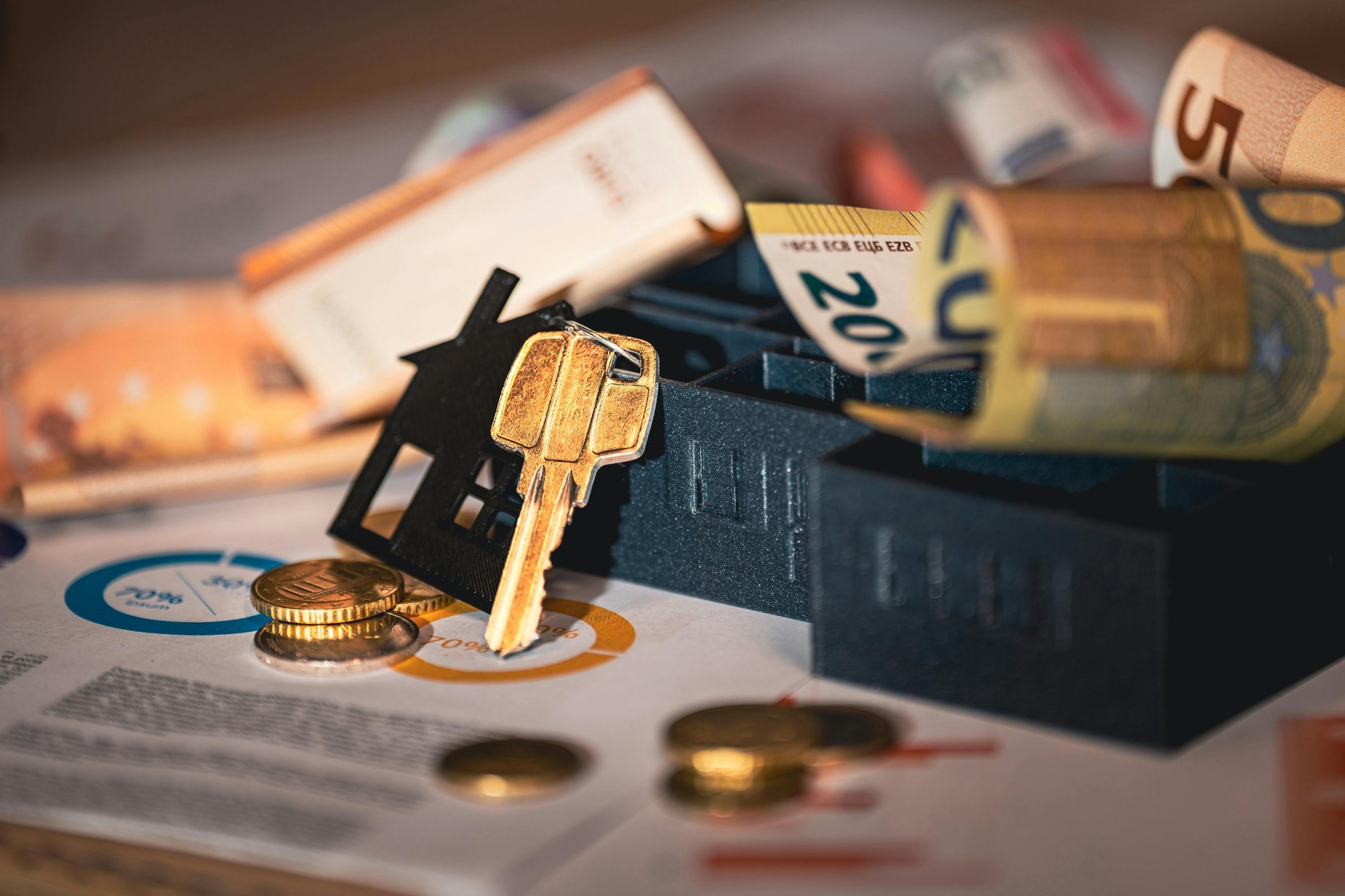 Real estate investment concept with house keys, Euro banknotes, and coins for property valuation